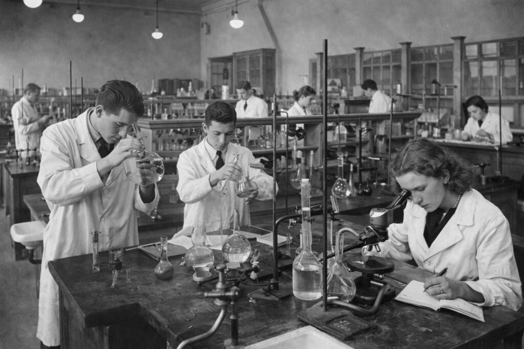 Old chemistry laboratory with students conducting experiments